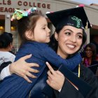 Marina Meres hugs her daughter Olivia after her graduation Thursday night.